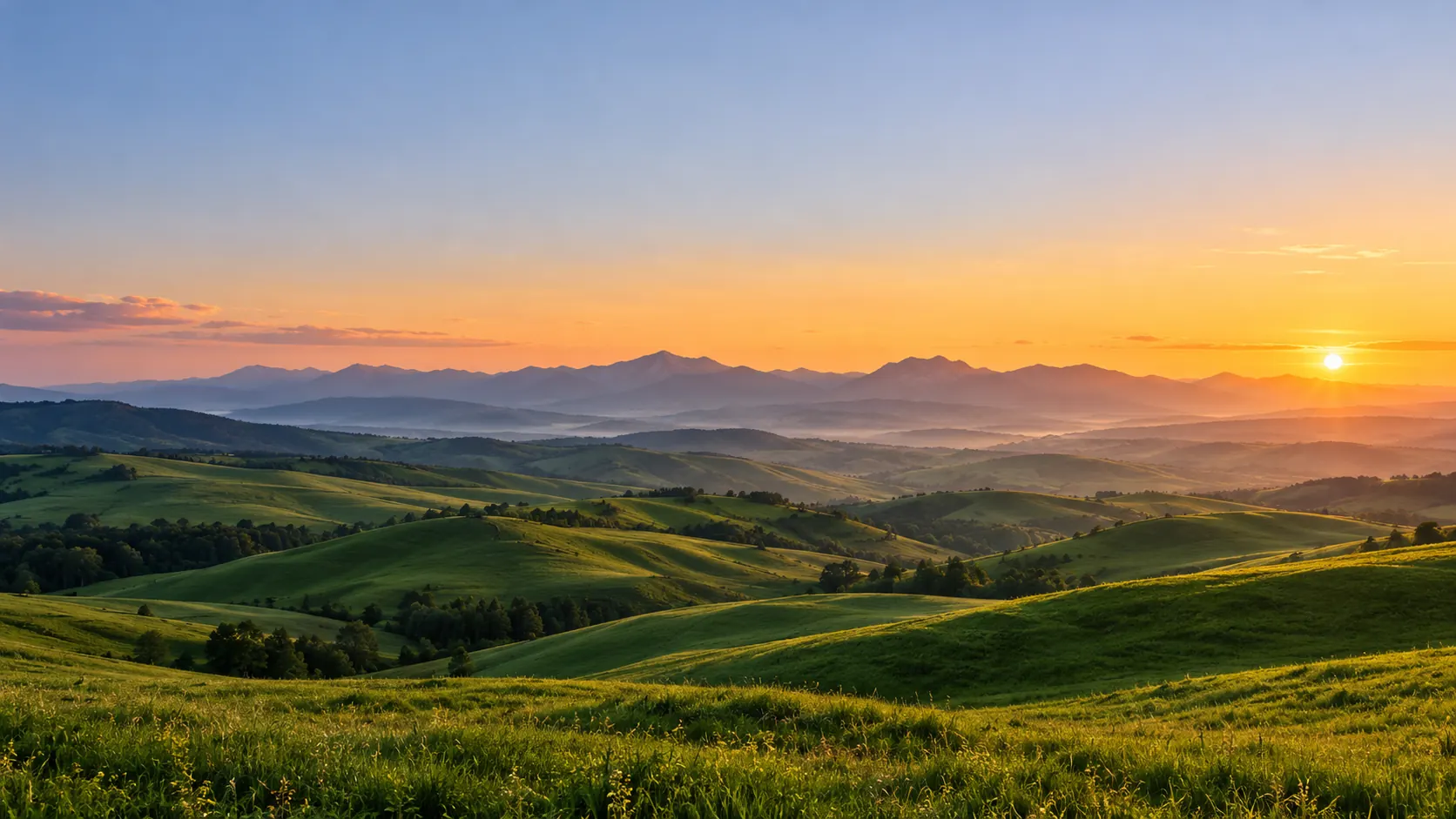 Rolling green hills under a golden evening sky